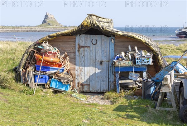 Old upturned boat used as store shed for fishing equipment, Holy Island, Lindisfarne,