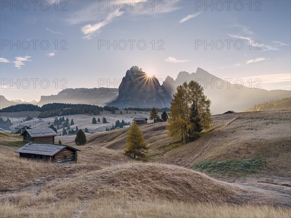 Autumn on the Seiser Alm, Alpine huts with Plattkofel and Langkofel, sunrise, sun star, frost,