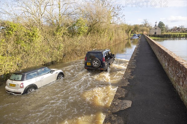 Land Rover Discovery Td5 vehicle driving through flood water at Kellaways, Wiltshire, England, UK