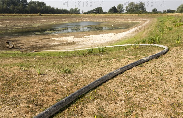 27 July 2018 Low water level in farm irrigation lake after long summer drought, Sutton, Suffolk