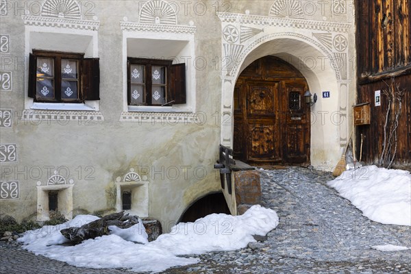 House entrance door, window, historic house, sgraffito, facade decorations, Guarda, Engadin,