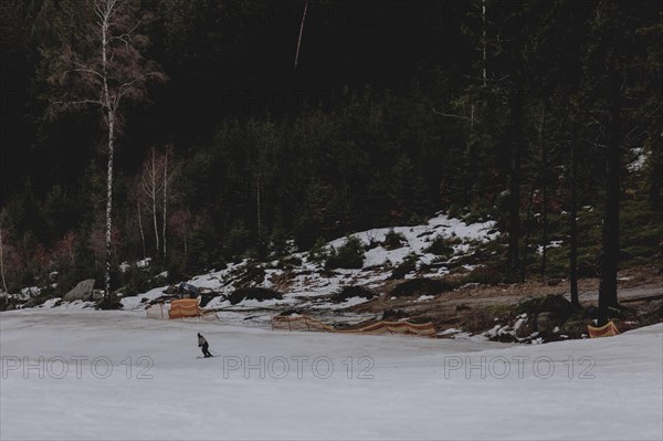 A skier skiing on a snow-covered slope, taken on a ski slope in the Jizera Mountains ski resort