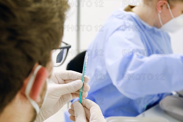 Syringes are filled with the Covid19 Biontech Pfizer vaccine Comirnaty in a vaccination centre by