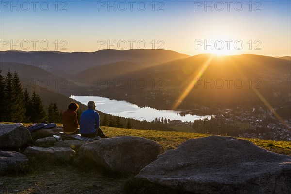 Elderly couple, view from Hochfirst to Titisee and Feldberg, sunset, near Neustadt, Black Forest,