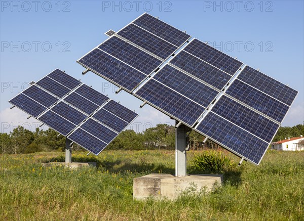 Solar panel array in rural location of field in countryside providing domestic energy near village