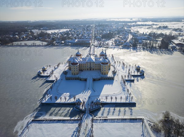 Moritzburg Castle on the castle island surrounded by the frozen castle pond, Moritzburg, Saxony,
