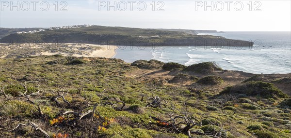 Panorama view of river mouth of Ribeira de Aljezur reaching the Atlantic Ocean and whitewashed