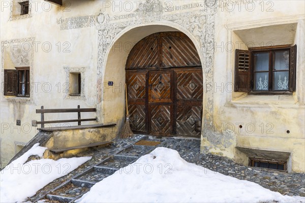 House entrance door, window, historic house, sgraffito, facade decorations, Guarda, Engadin,