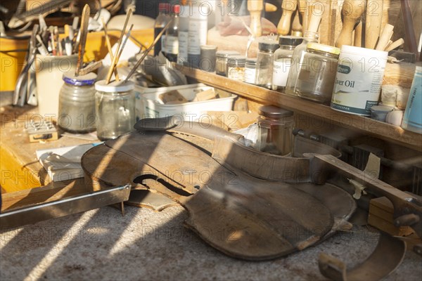 Workbench seen through shop window of the Violin Shop, Market Hill, Woodbridge, Suffolk, England,