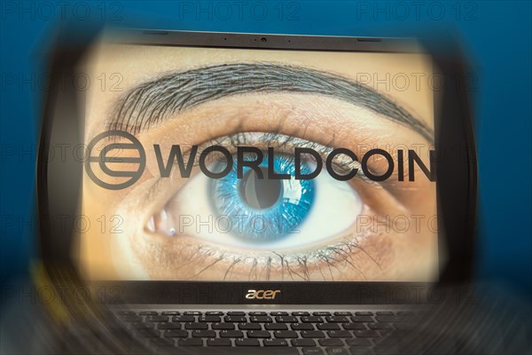 Logo of the new cryptocurrency Worldcoin on a laptop. Anyone wishing to participate in World Coin
