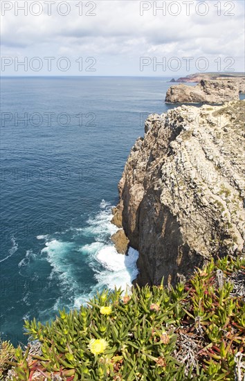 Sheer cliffs rise from Atlantic Ocean at Cabo de Sao Vicente, Cape St Vincent, Algarve, Portugal