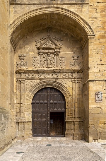 Stonework carvings around wooden doorway to church of Santa Maria de la Asuncion, Briones, La Rioja