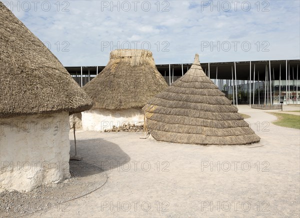 Reconstruction of neolithic homes thatched round houses huts, Stonehenge, Wiltshire, England, UK