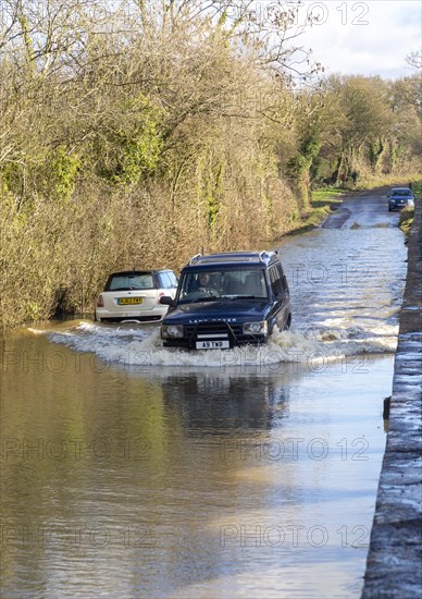 Land Rover Discovery Td5 vehicle driving through flood water at Kellaways, Wiltshire, England, UK