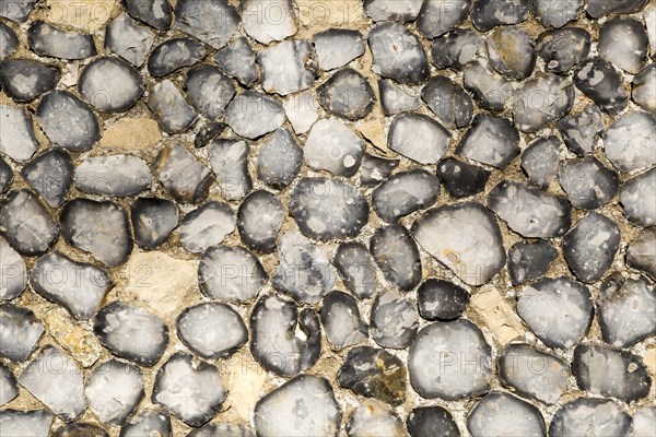 Dressed stone flint wall stonework facing flush work exterior of church of Saint John, Saxmundham,