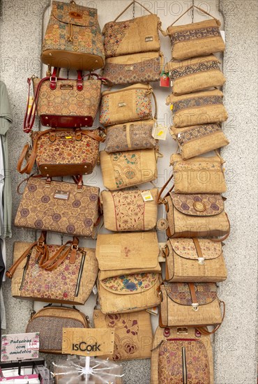 Close up of shop display of handbags made from cork oak souvenir products of butterflies and fish