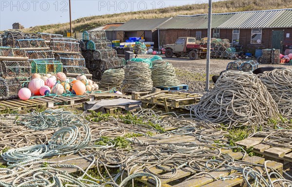 Fishing ropes, lobster pots and equipment on quayside Holy Island, Lindisfarne, Northumberland,