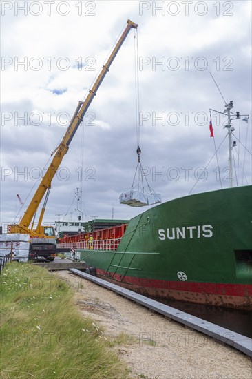 Crane unloading cargo ship Suntis at Anglo-Norden timber merchants, Wet Dock, Ipswich, Suffolk,