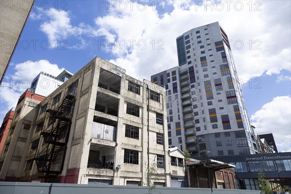 Contrast derelict industrial building modern housing development high rise flats, Wet Dock