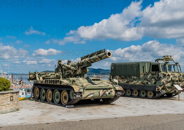 SeosanEight inch self-propelled gun beside M548 tracked cargo carrier on display at seaside park in