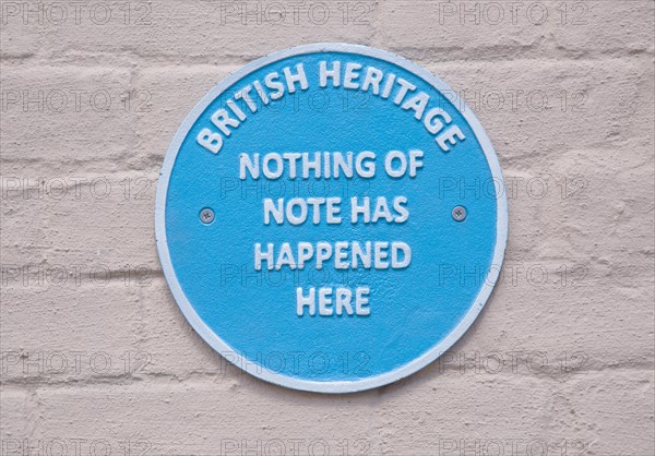 Humorous fake blue plaque sign on wall of house 'British Heritage Nothing of Note Has Happened