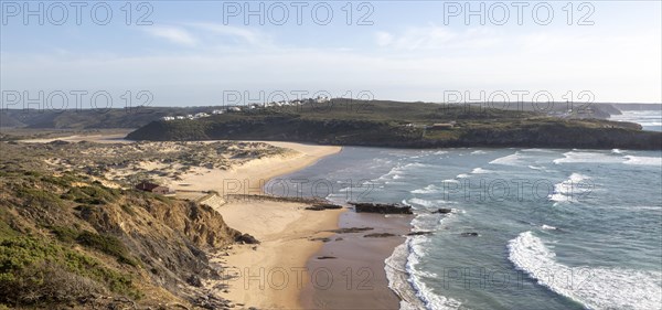 Panorama view of river mouth of Ribeira de Aljezur reaching the Atlantic Ocean and whitewashed
