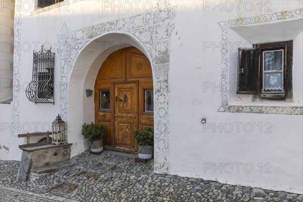 Entrance door, window, historic house, sgraffito, facade decorations, Guarda, Engadin, Grisons,