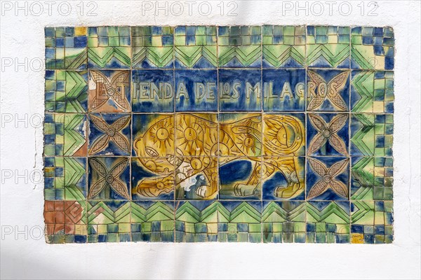 Tiles forming sign for ceramic and textile shop, La Tienda de los MIlagros, Nijar, Almeria, Spain,