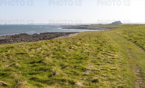 Coastline landscape scenery looking south towards Farne Islands and castle, Holy Island,