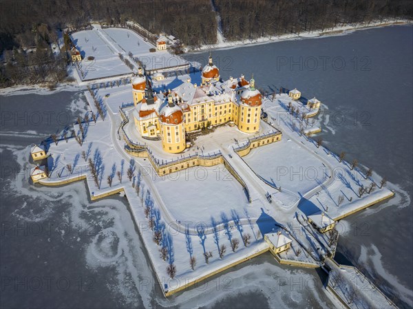Moritzburg Castle on the castle island surrounded by the frozen castle pond, Moritzburg, Saxony,