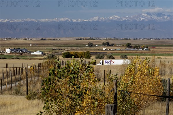 Keenesburg, Colorado, A FedEx truck on a rural road on Colorado's eastern plains, with the Rocky