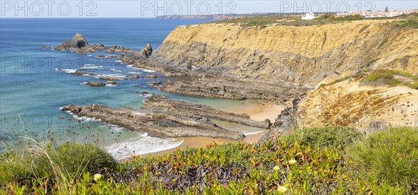 Rocky coastal landscape Praia dos Alteirinhos beach in bay with rocky headland part of Parque