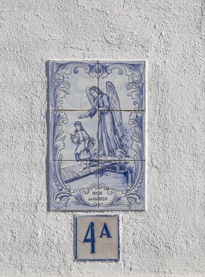 Azulejo tile ceramic image of guardian angel above house door, village of Alvito, Baixo Alentejo,