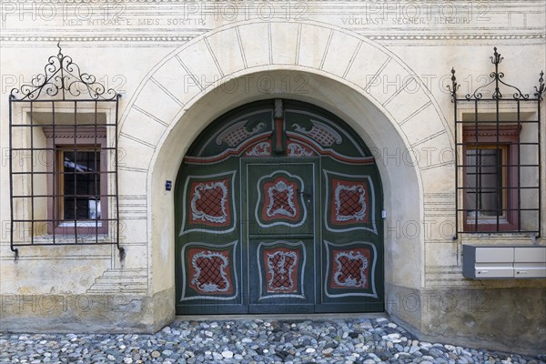 Large painted wooden door, window, historic house, sgraffito, facade decorations, Ardez, Engadin,