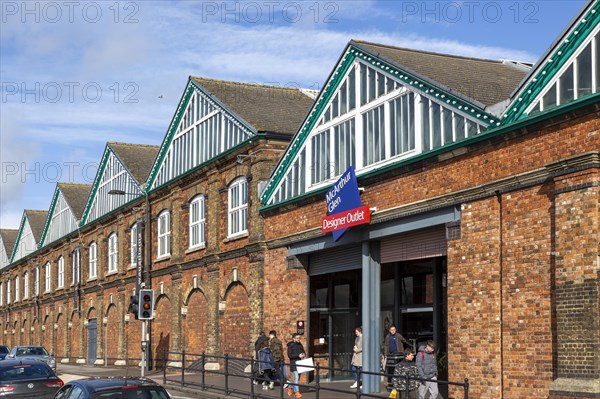 McArthur Glen designer outlet west entrance into former railway works, Swindon, Wiltshire, England,