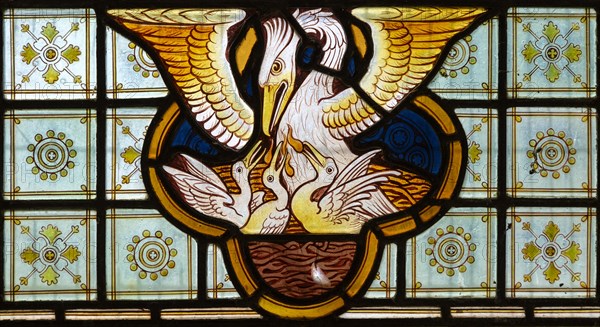 Stained glass window Bedingfield church, Suffolk, England, UK c 1878, detail of pelican feeding its