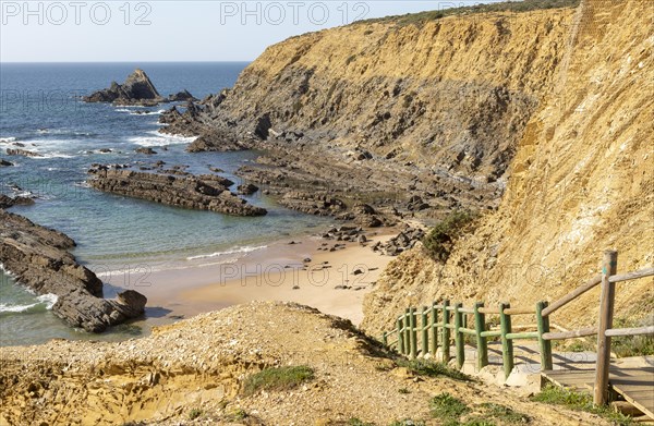 Rocky coastal landscape Praia dos Alteirinhos beach in bay with rocky headland part of Parque