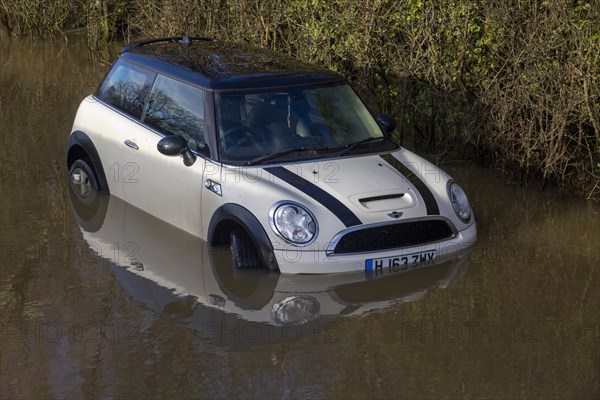 Mini Cooper S car stuck in River Avon flood water, Kellaways bridge, Wiltshire, England, UK