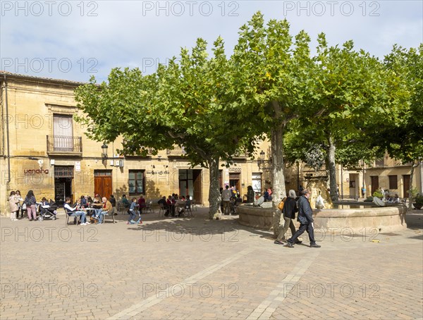 People sitting outside a cafe in Plaza Mayor, village of San Vicente de la Sonsierra, La Rioja,