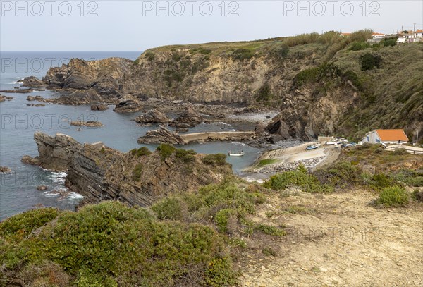 Rocky rugged coastline near fishing port village of Azenha do Mar, Alentejo Littoral, Portugal,