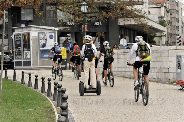 Tourists on a cruise ship during a shore excursion with bicycles and Segway, Praca Marques de