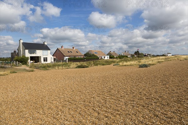 On the left is Ronina, former MOD house redesigned by Casswell Bank architects on beach at Shingle