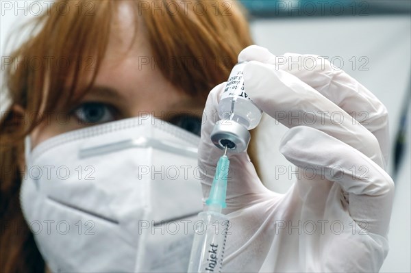 Drawing up a syringe with the Biontech Pfizer active ingredient Comirnaty against Covid19 in a
