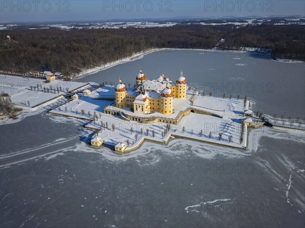Moritzburg Castle on the castle island surrounded by the frozen castle pond, Moritzburg, Saxony,