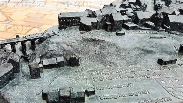 The historic city centre of Dingolfing with a view of the bronze city map. Dingolfing, Lower