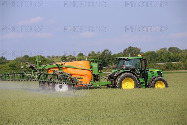 A farmer from the Schmitt vegetable farm in Hockenheim drives his tractor with a crop protection