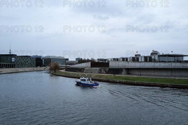 A police boat travels up the River Spree close to the German Bundestag building on a day of