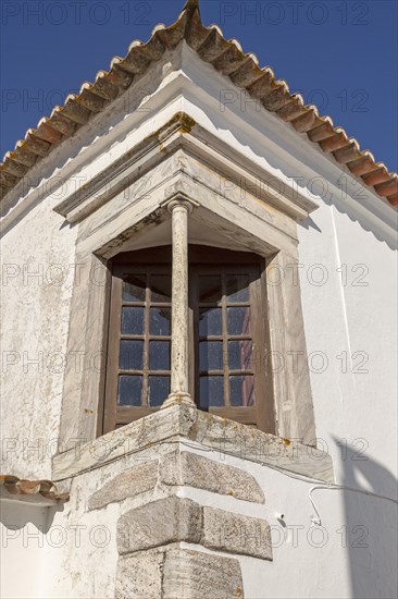 Window balcony and architectural detail of building inside historic walled hilltop village of