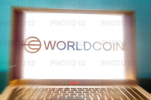 Logo of the new cryptocurrency Worldcoin on a laptop. Anyone wishing to participate in World Coin
