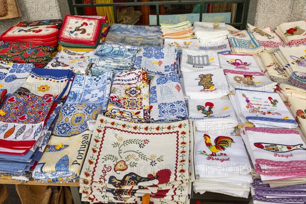 Display of tea towel textile souvenir products of butterflies and fish on sale, city of Evora, Alto